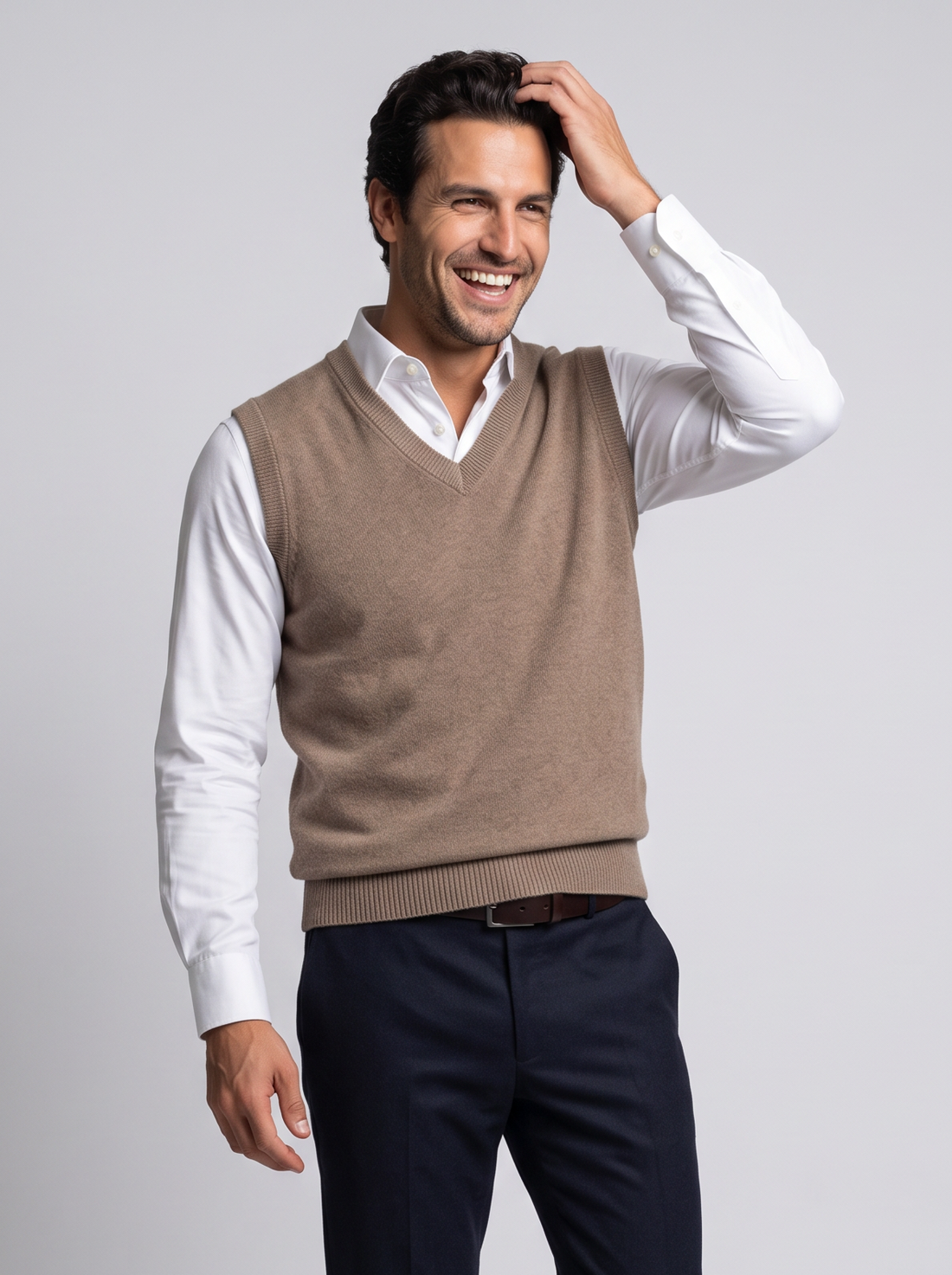 Smiling man in camel merino wool sweater vest over white shirt