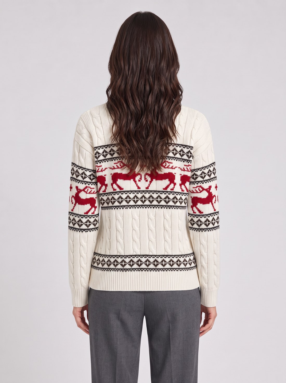 Woman wearing ivory Fair Isle Christmas sweater with red reindeer, front view