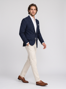 Men's navy windowpane tailored blazer, side view walking