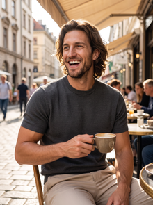 Man wearing dark grey fine knit t-shirt at a café terrace