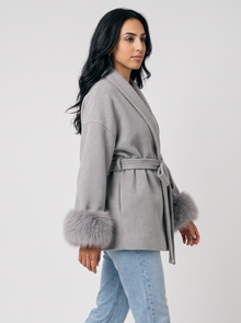 Women's grey belted wool blend wrap coat, side view walking