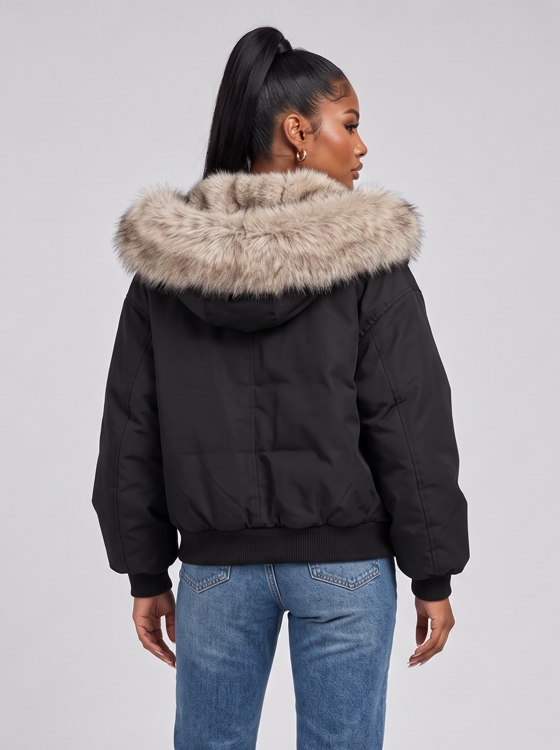 Women's black puffer jacket with faux fur hood, back view