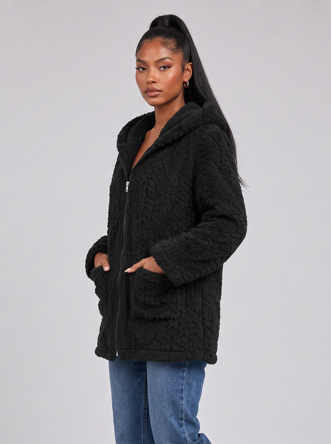 Women's black hooded teddy fleece jacket, side view walking
