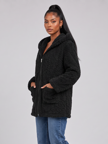 Women's black hooded teddy fleece jacket, side view walking