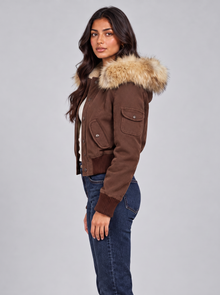 Women's brown bomber jacket with beige faux fur hood, side view