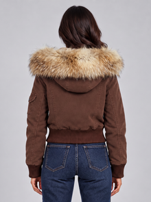 Women's brown bomber jacket with beige faux fur hood, back view