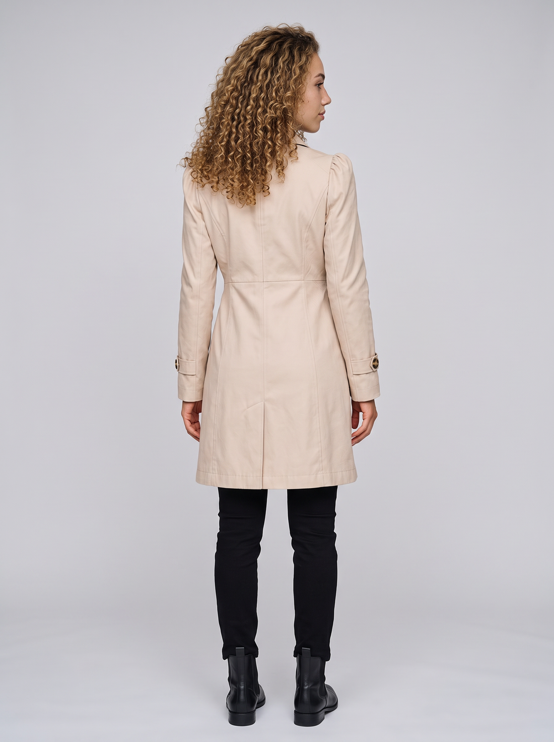 Women's fitted beige trench coat, back view