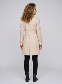 Women's fitted beige trench coat, back view