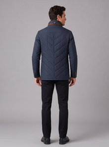 Back view of navy quilted jacket with chevron quilting
