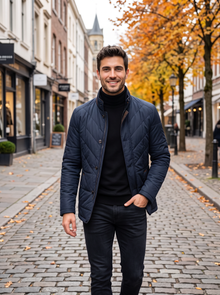 Man wearing navy quilted jacket walking down an autumn street