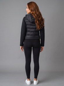 Back view of black cropped hooded puffer jacket with quilted body