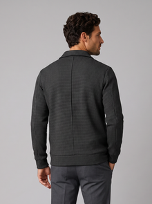 Back view of men's black textured athletic jacket