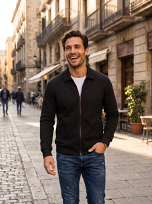 Man in black textured jacket walking on a sunny city street