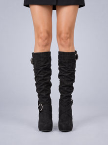 Black suede slouchy knee-high stiletto boots with ring buckles, front view