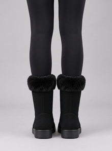 Back view of black mid-calf wedge boots with faux fur trim