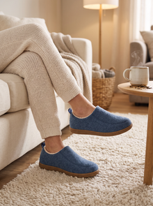 Blue fleece-lined house slippers worn relaxing at home