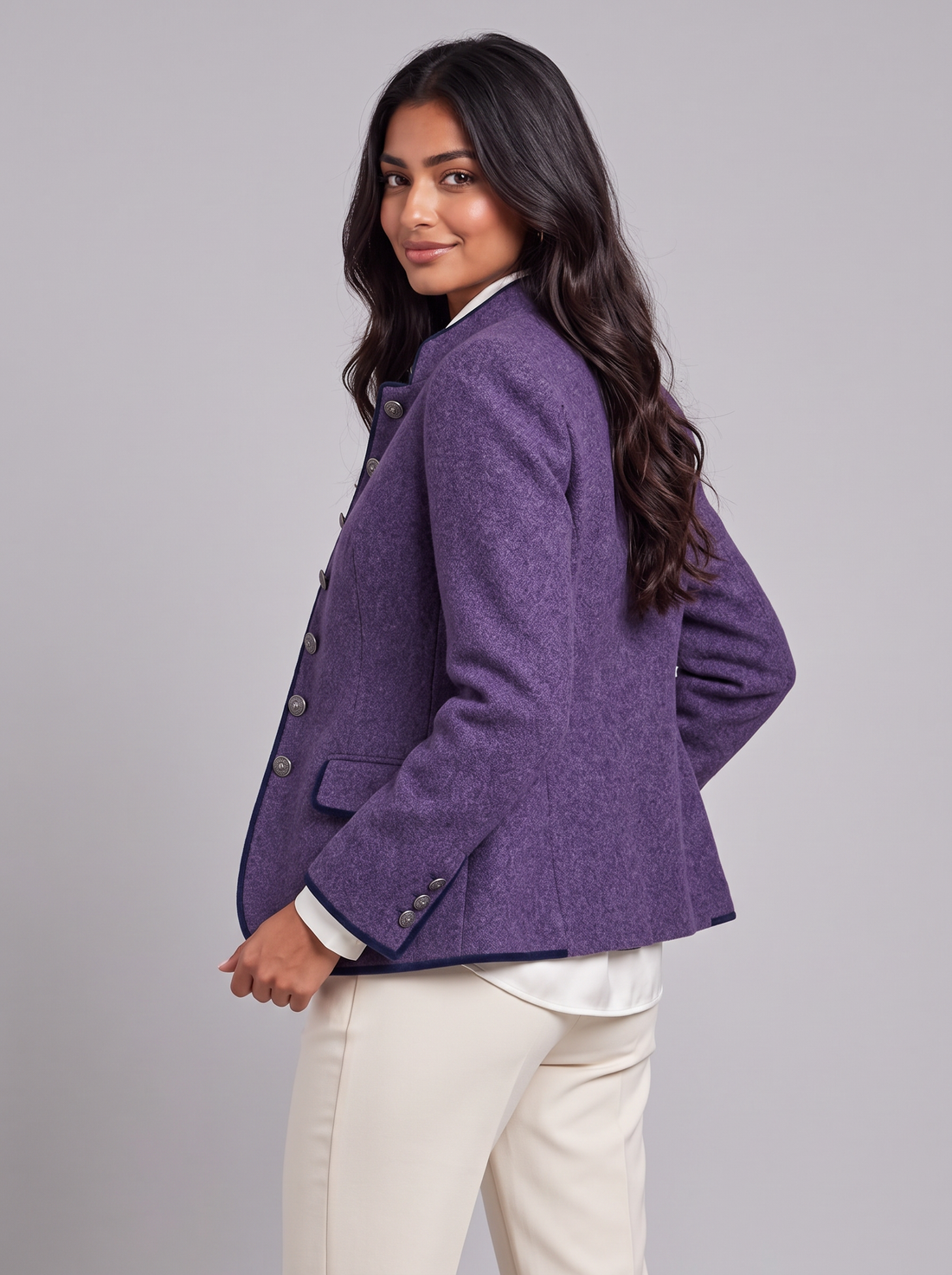 Women's purple wool-blend blazer with stand collar and navy piping, glancing over shoulder