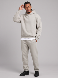 Men's light grey oversized hoodie and tapered joggers tracksuit set