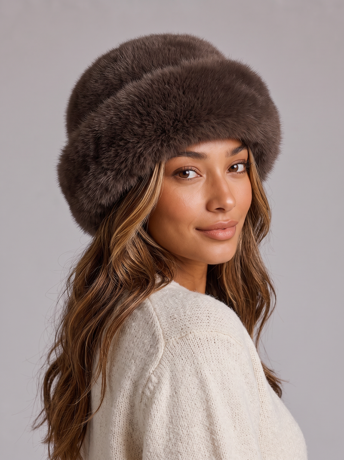 Woman wearing a brown faux fur hat with a rolled brim
