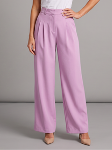 Woman wearing pink pleated wide leg trousers