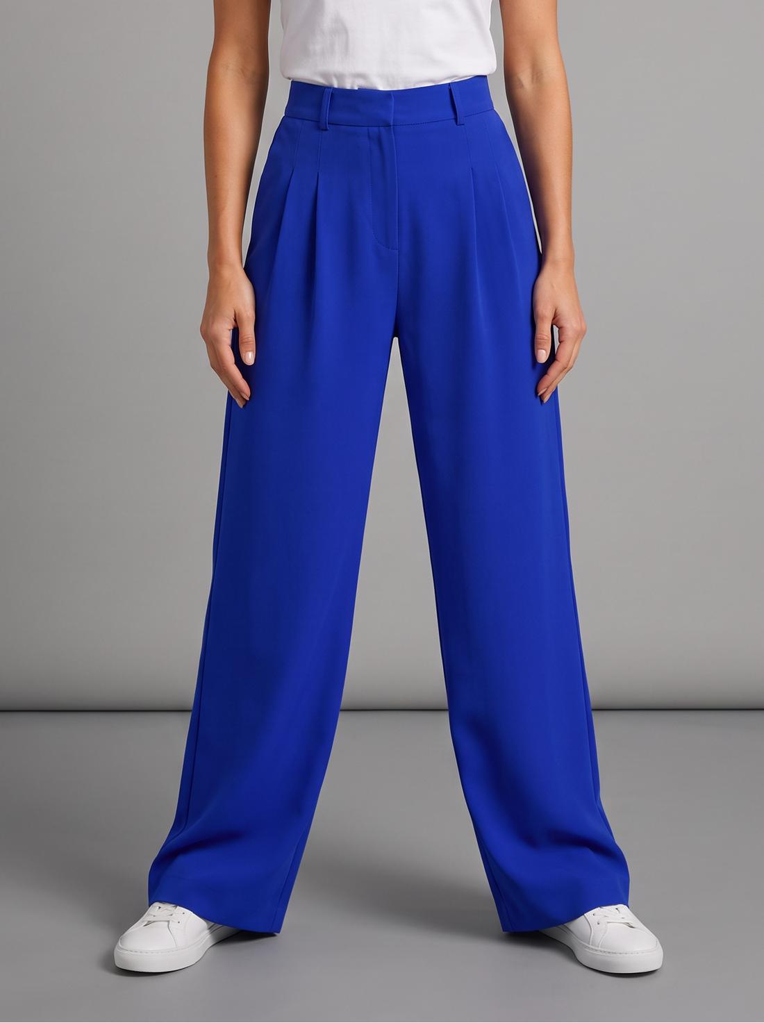 Woman wearing royal blue pleated wide leg trousers