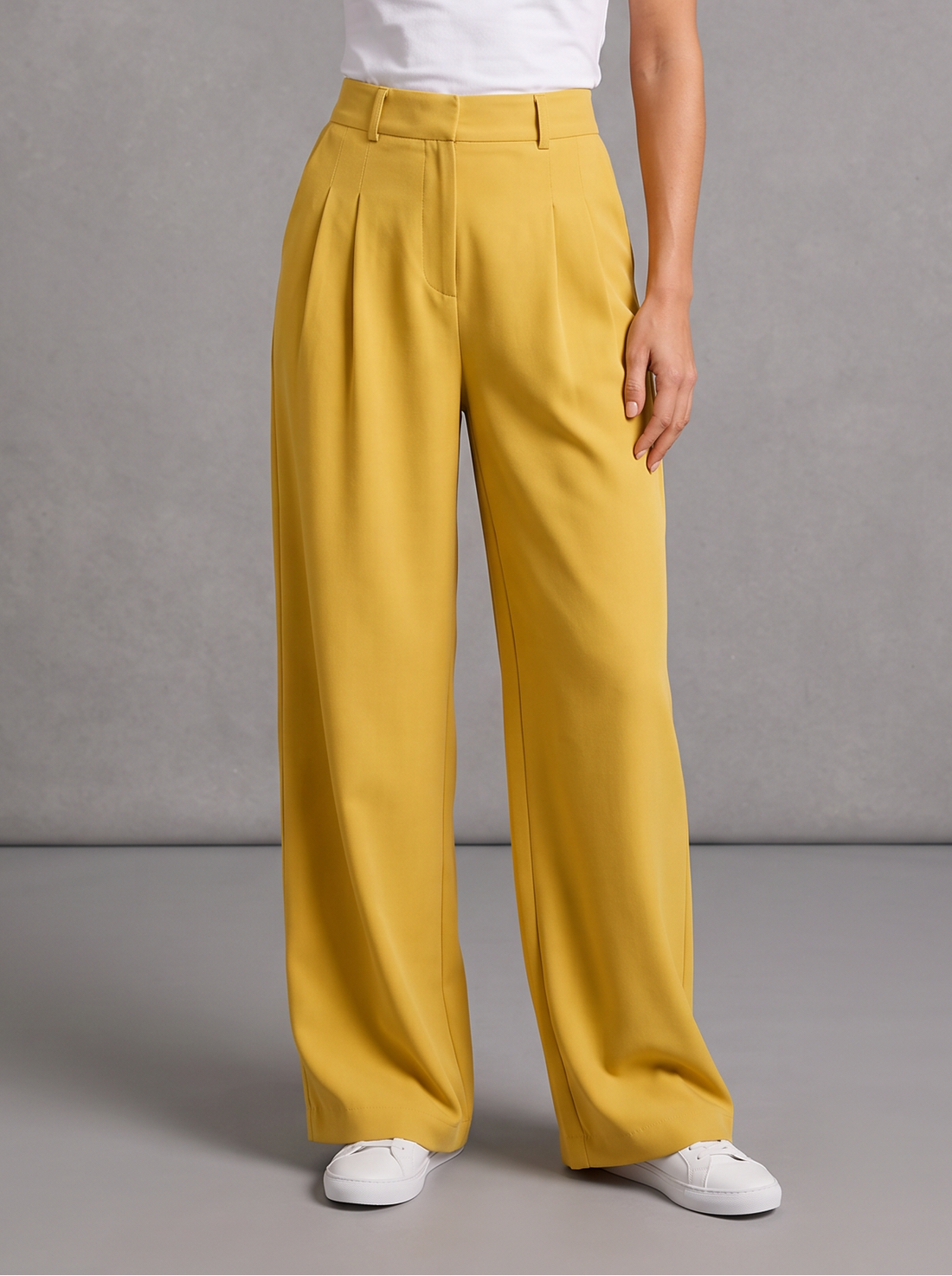 Woman wearing yellow pleated wide leg trousers