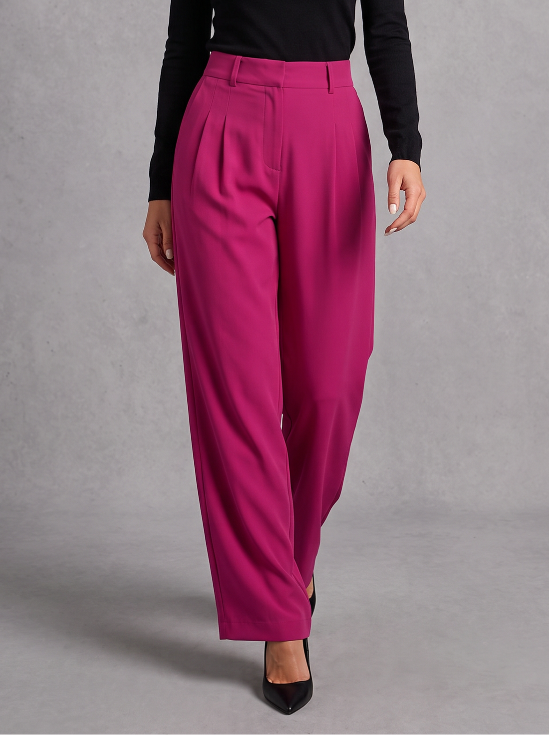 Woman wearing rose red pleated wide leg trousers