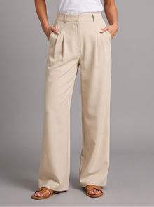 Woman wearing apricot pleated wide leg trousers
