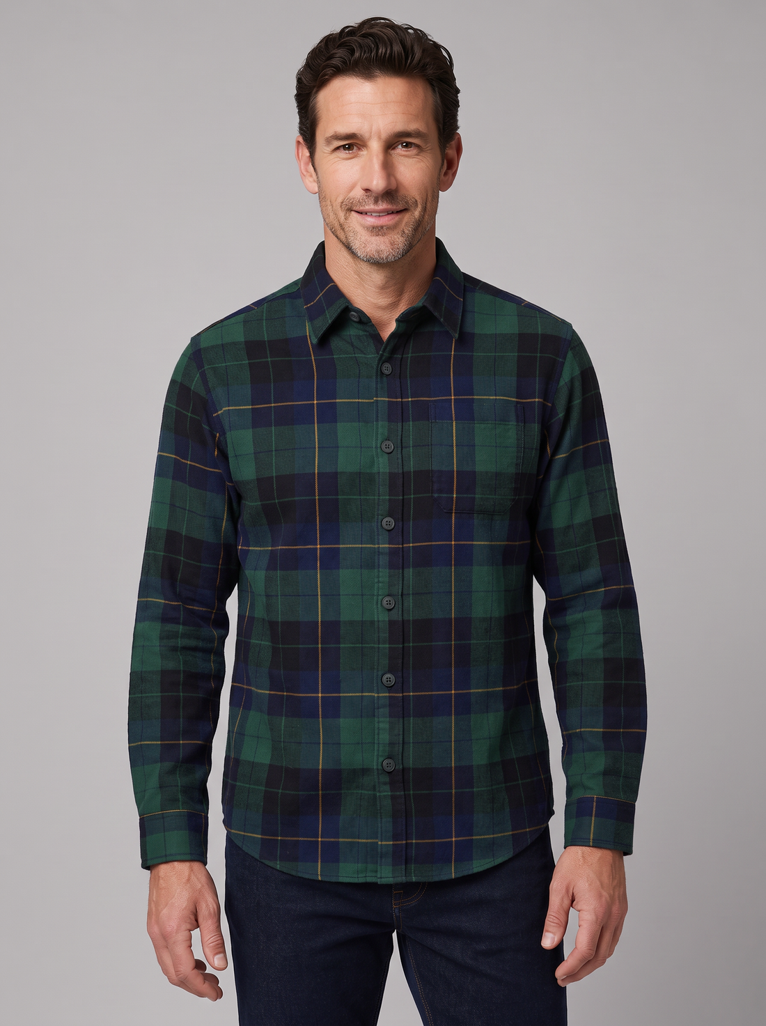 Man wearing a green and navy Blackwatch plaid flannel shirt, front view