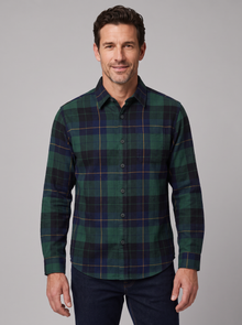 Man wearing a green and navy Blackwatch plaid flannel shirt, front view