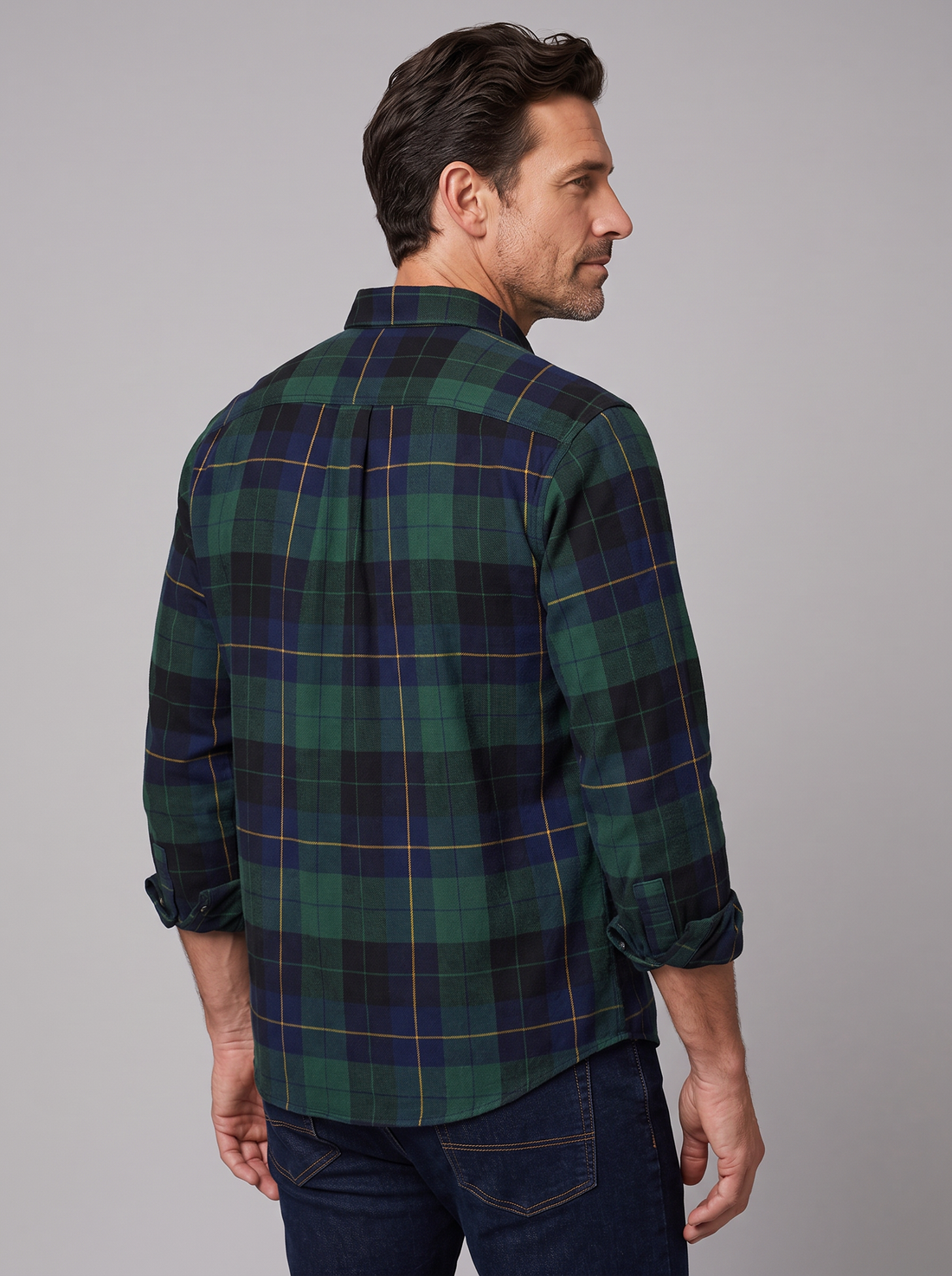 Man wearing a green and navy Blackwatch plaid flannel shirt, front view