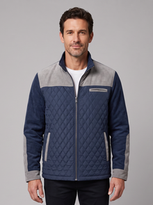 Man wearing a navy diamond quilted jacket with light grey contrast panels