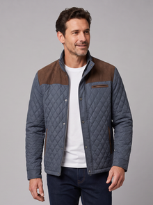 Man walking in a diamond quilted contrast panel jacket and jeans