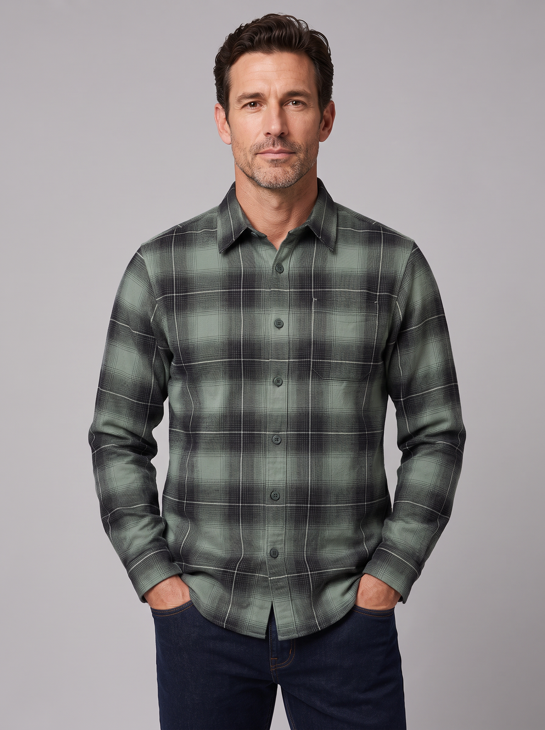 Man wearing a dark sage plaid flannel shirt