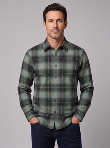 Man wearing a dark sage plaid flannel shirt