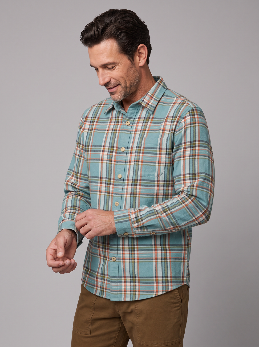 Man wearing a dark seafoam plaid flannel shirt