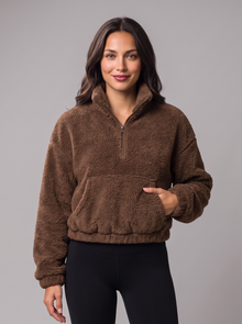 Woman wearing brown teddy fleece half-zip jumper with kangaroo pocket, front view