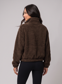 Back view of brown fleece half-zip jumper with funnel collar