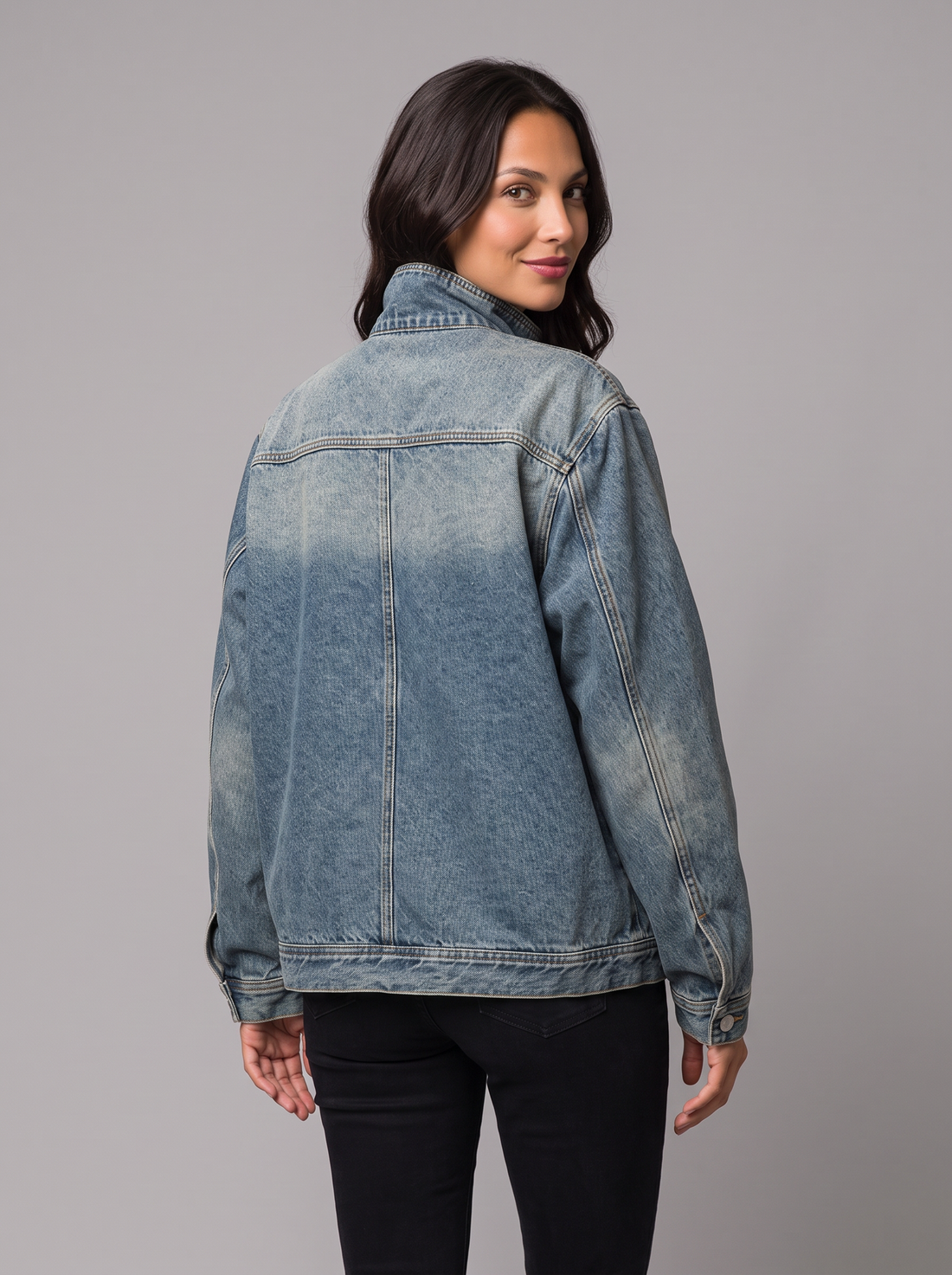Woman wearing oversized high neck blue denim jacket, front view