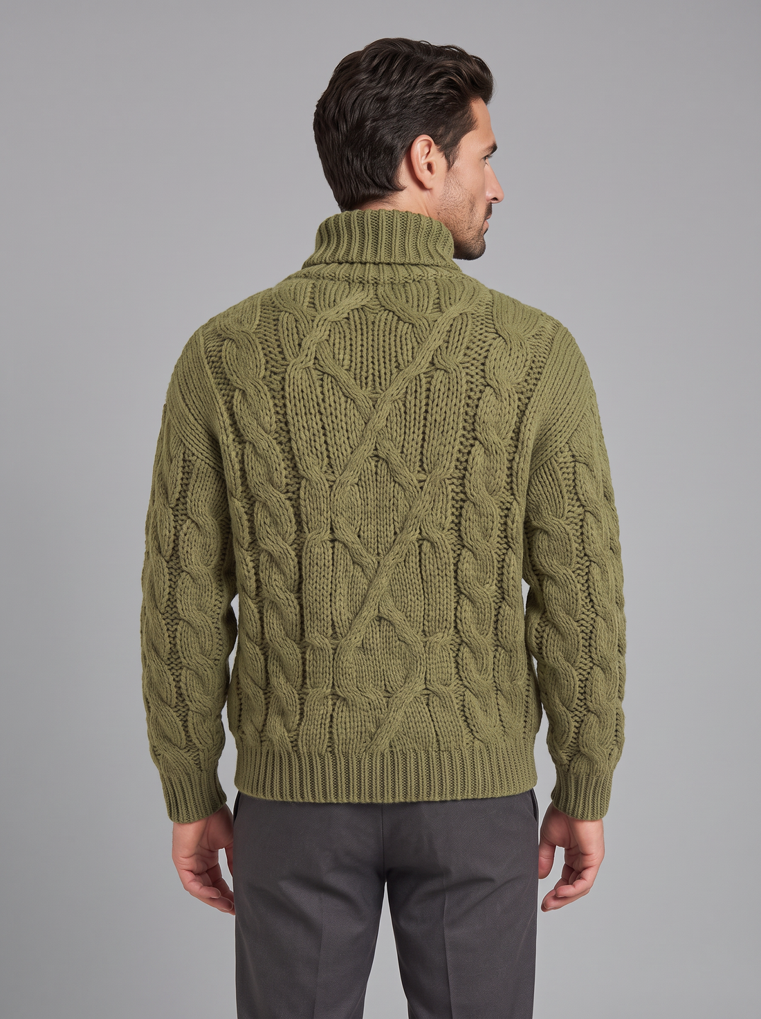 Man wearing olive green chunky cable knit roll neck jumper, front view