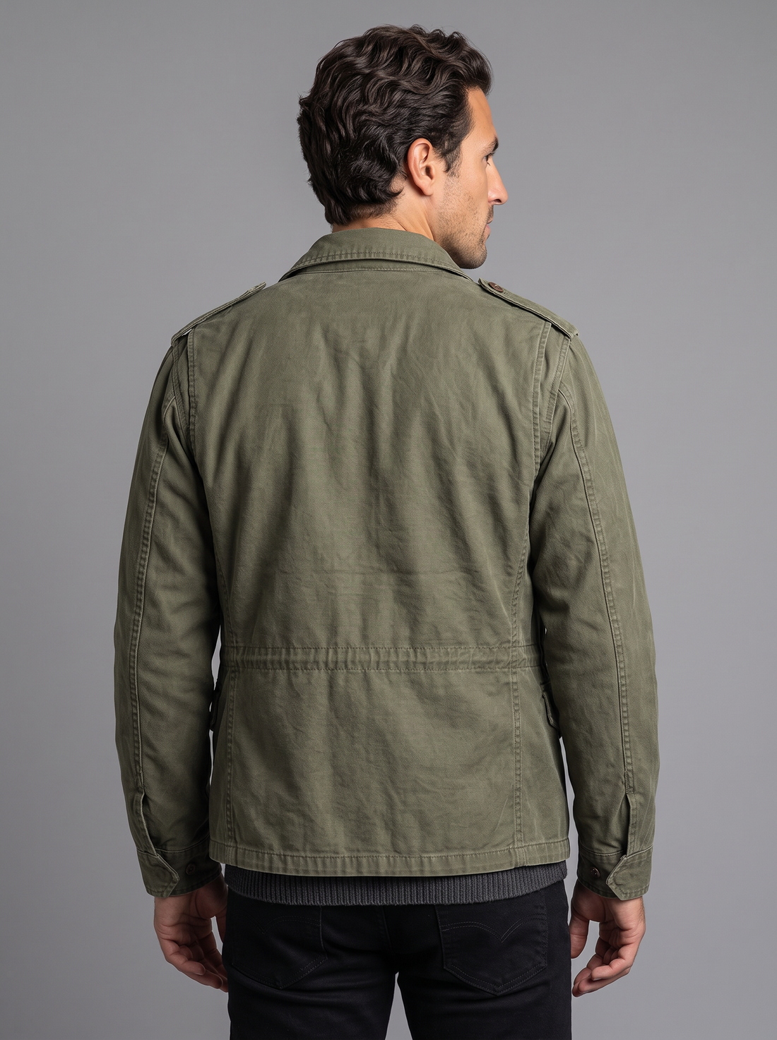 Man wearing olive green vintage military field jacket, front view