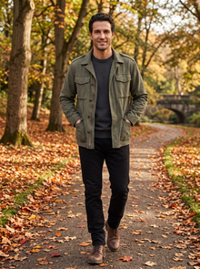 Man walking an autumn park path in green military field jacket