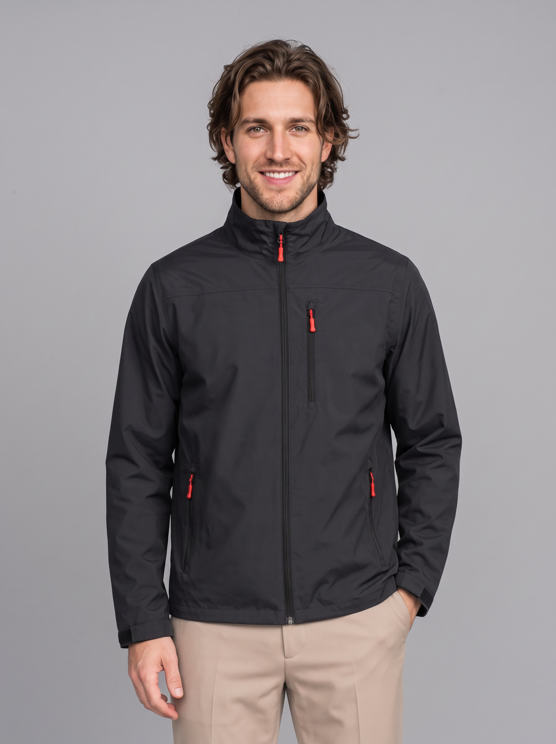 Man wearing black waterproof rain jacket with stand collar, front view