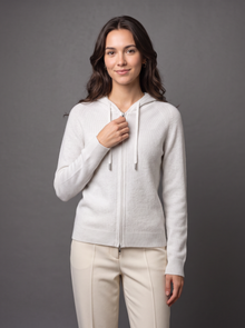 Woman wearing white knit zip hoodie cardigan