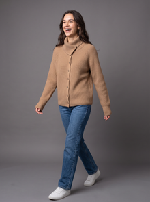 Woman walking in camel wool cashmere knit cardigan with jeans