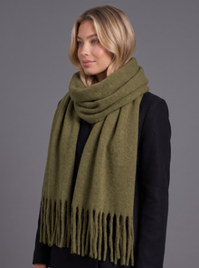 Woman wearing army green tassel wrap scarf