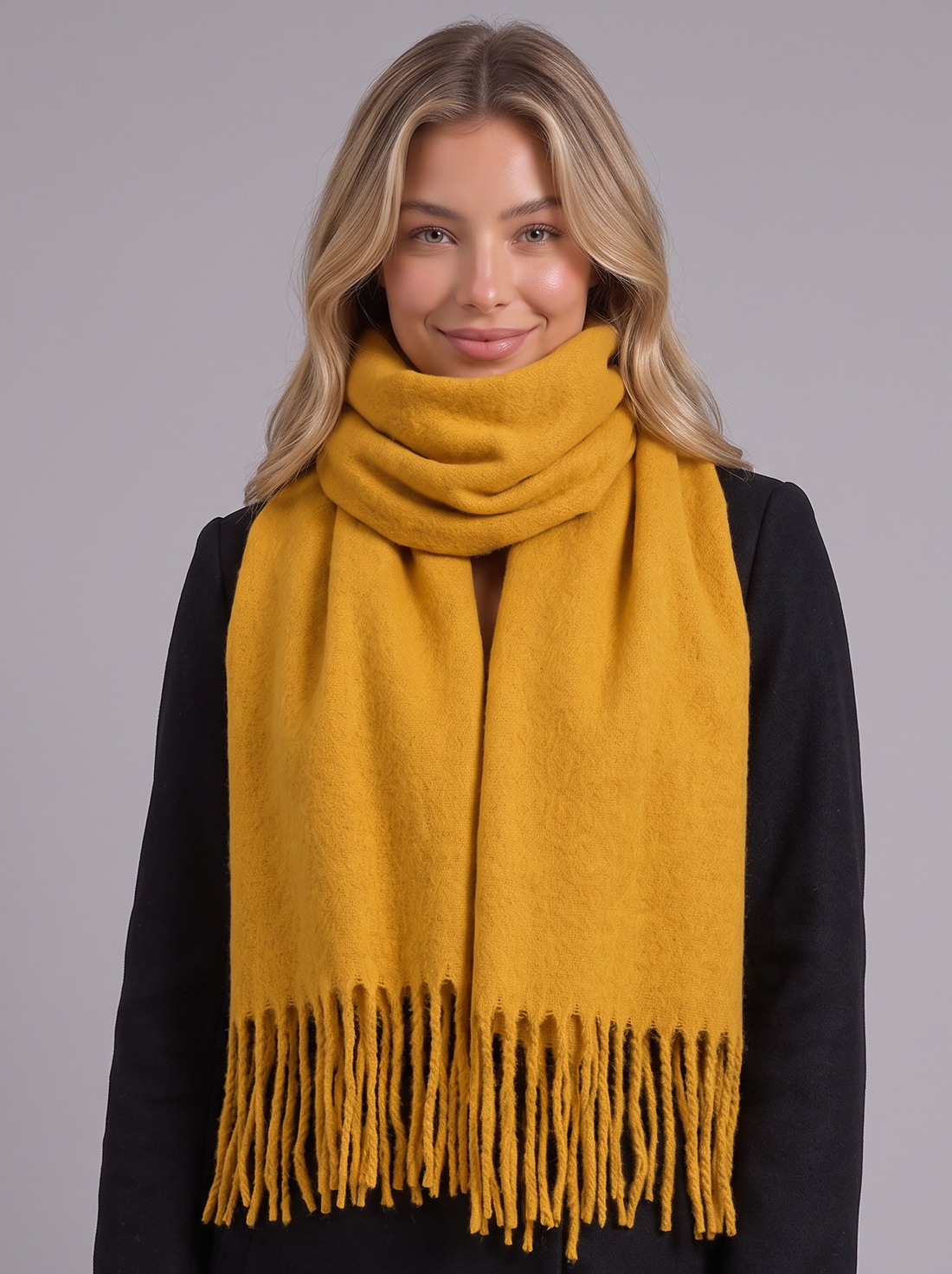 Woman wearing mustard yellow tassel wrap scarf