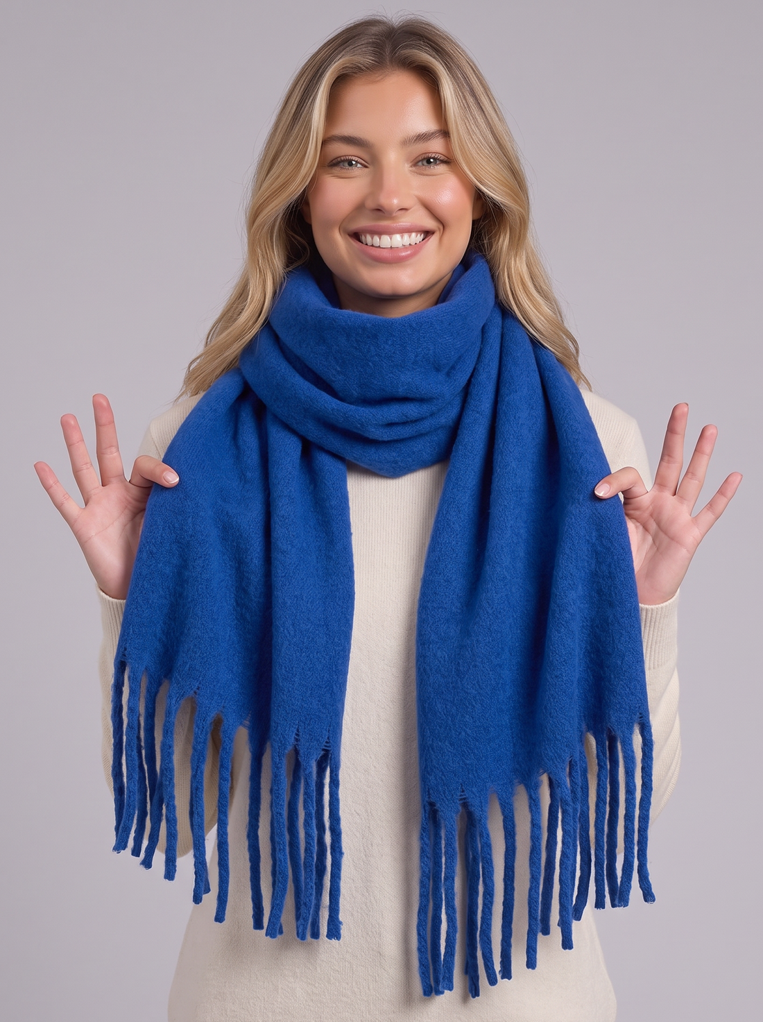 Woman wearing blue tassel wrap scarf
