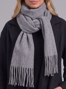 Woman wearing grey tassel wrap scarf