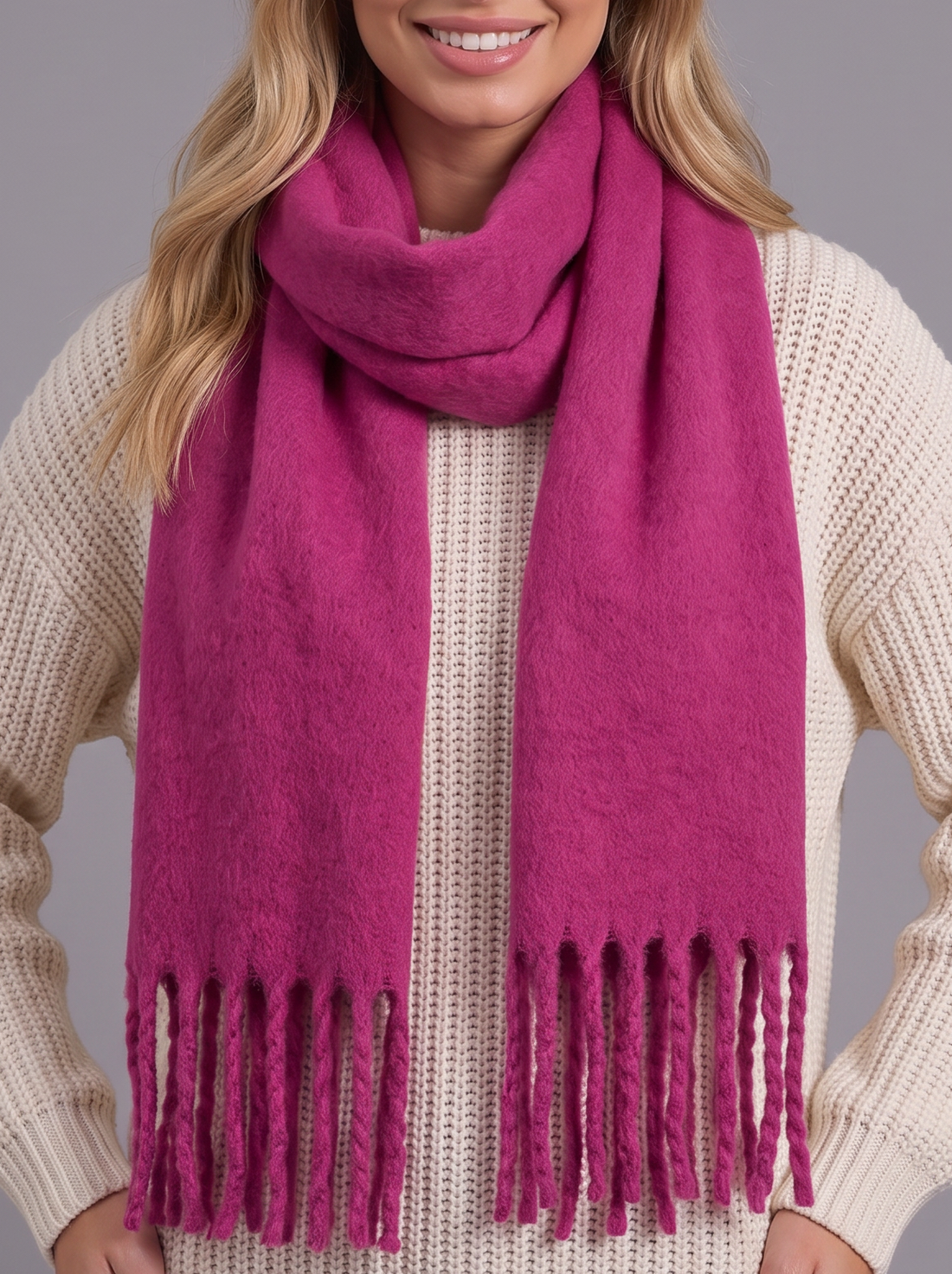 Woman wearing magenta tassel cashmere wrap scarf, front view